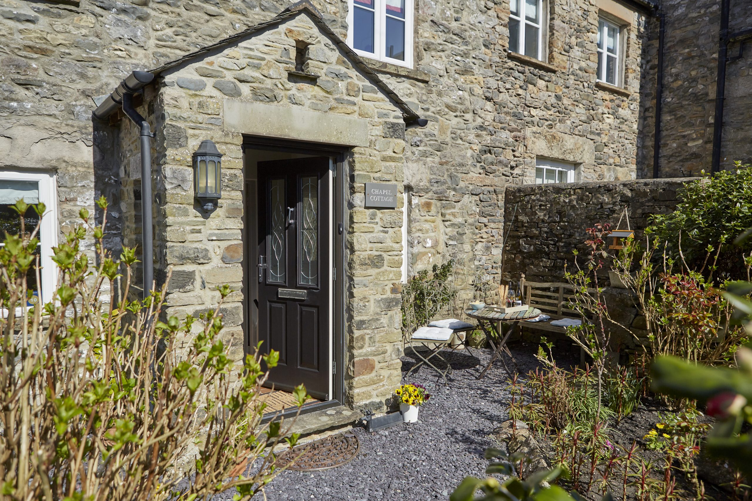 The stone front of Chapel Cottage with its courtyard garden